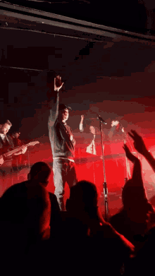 a man stands in front of a red light