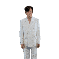 a man in a white suit is dancing with his arms outstretched