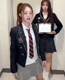 a girl in a school uniform holds a clipboard that says thursday on it