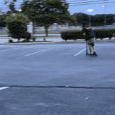 a man is riding a scooter on a parking lot
