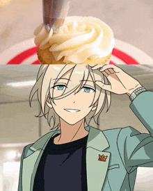 a cupcake with white frosting and a man with a crown on his jacket