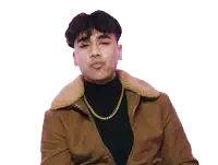 a young man wearing a brown jacket and a gold chain makes a funny face
