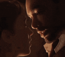 a man and a woman are looking into each other 's eyes .