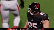 a football player for the cardinals stands on the field during a game