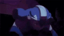 a close up of a person in a blue costume in a dark room .