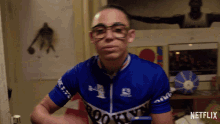 a man wearing glasses and a blue brooklyn jersey is featured on netflix