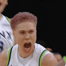 a basketball player with pink hair is screaming with his mouth wide open
