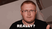a man with red hair and glasses is asking " really "
