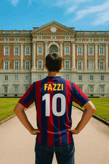 a man wearing a shirt with the number 10 on it stands in front of a building
