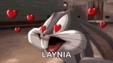 bugs bunny is surrounded by red hearts and has his eyes closed .