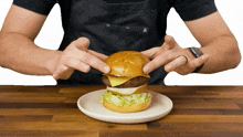putting the bun on top internet shaquille preparing a burger preparing food cheeseburger