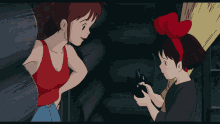 a girl with a red bow on her head holds a black object