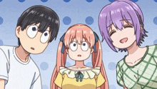 a boy and two girls are standing next to each other on a polka dot background