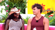 a man and a woman are sitting next to each other on a couch