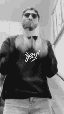 a black and white photo of a man wearing a shirt that says yay