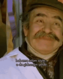 a man with a mustache and a hat says babama selam soyle o da gidecegin yerde