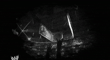 a black and white photo of a fence with a wwe logo in the corner