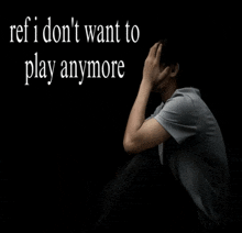 a man sits in a dark room with the words " ref i don 't want to play anymore " above him