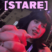 a woman 's face is shown with the words [ stare ] above her head