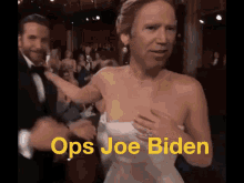 a woman in a white dress is dancing with a man in a tuxedo and the words ops joe biden written in yellow
