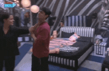 a man in a red shirt is standing next to a woman in a bedroom with an arrow pointing to the live channel