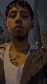 a man with a tattoo on his chest that says ' y '