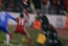 a blurry picture of a soccer game with a player wearing the number 18