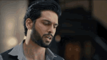 a man with a beard is smoking a cigarette in a close up of his mouth .