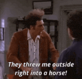a man in a brown jacket is saying they threw me outside right into a horse