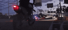 a man is riding a motorcycle in front of a sign that says ' gallo '