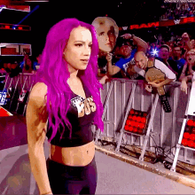 a woman with purple hair is wearing a shirt that says world heavyweight wrestling