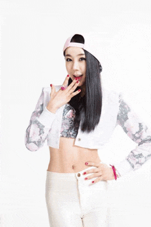 a woman wearing a hat and a crop top
