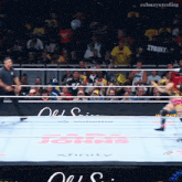 a wrestler in a yellow shirt that says tyosky