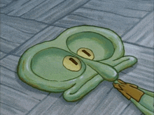 squidward from spongebob squarepants laying on the ground