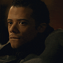a close up of a man 's face with his eyes closed