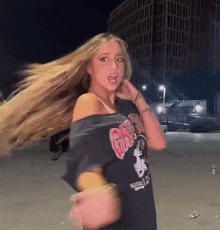 a woman with long blonde hair is wearing a black t-shirt with the word grizzlies on it
