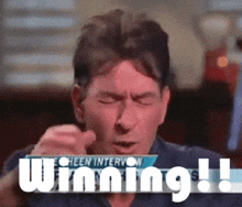 a man with his eyes closed is holding a sign that says " winning "