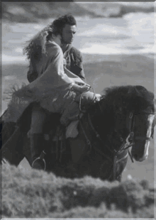 romantic couple horseback riding black and white