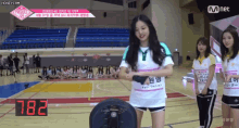 a group of girls are standing on a basketball court and one of them is wearing a shirt that says y