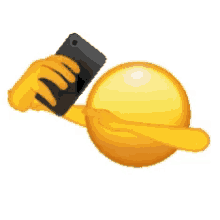 a smiley face is holding a cell phone in its hand .