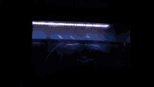 a dark room with a blue light shining on the ceiling