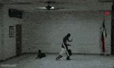 a man is standing in a room with a dog and a ceiling fan
