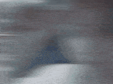 a blurred image of a person 's face with a blue background