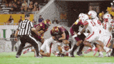 a football player with the number 18 on his jersey is being tackled