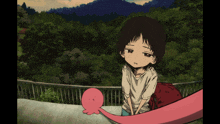 a girl is standing next to a pink octopus on a fence