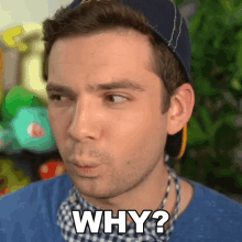 a man wearing a hat and a blue shirt is asking why