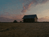 a house in the middle of a dirt field
