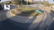 a roundabout with a sign that says " true " in the corner