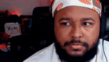a man with a beard wearing headphones and a bandana that says you 're 2011