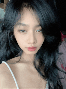 a close up of a woman with long black hair